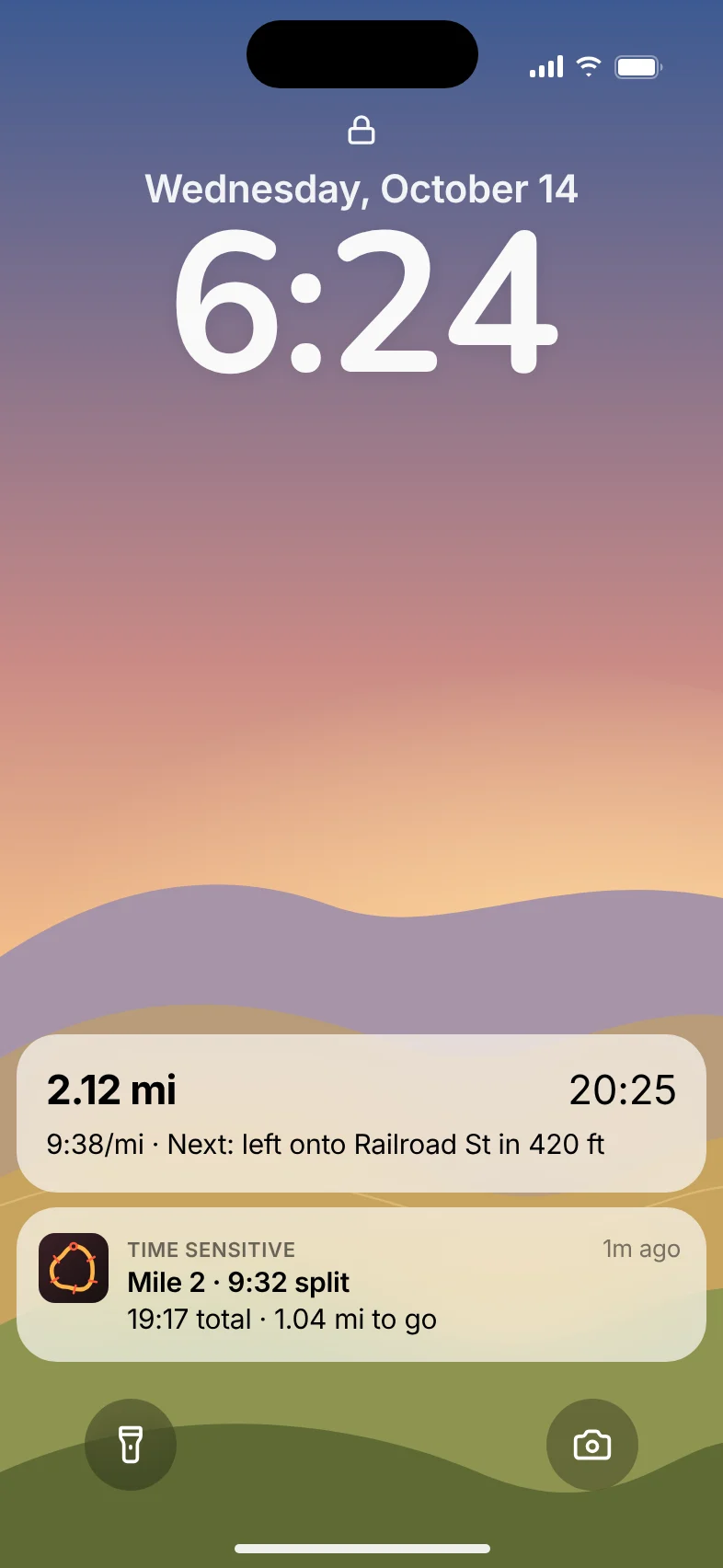The lock screen during a run, with MileDial's live progress and a Mile 2 split alert.
